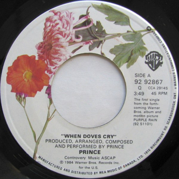 Vinyl record label with floral design and text about Prince's 'When Doves Cry'.